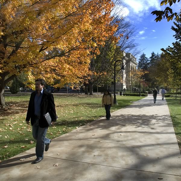 Students walk along the Old Main mall in the fall.