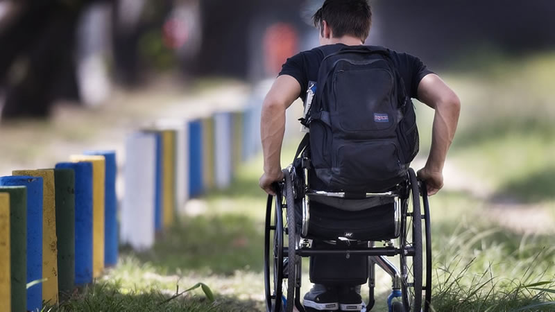 Journalism student Brett Gravatt navigates his wheelchair on a street in Rio