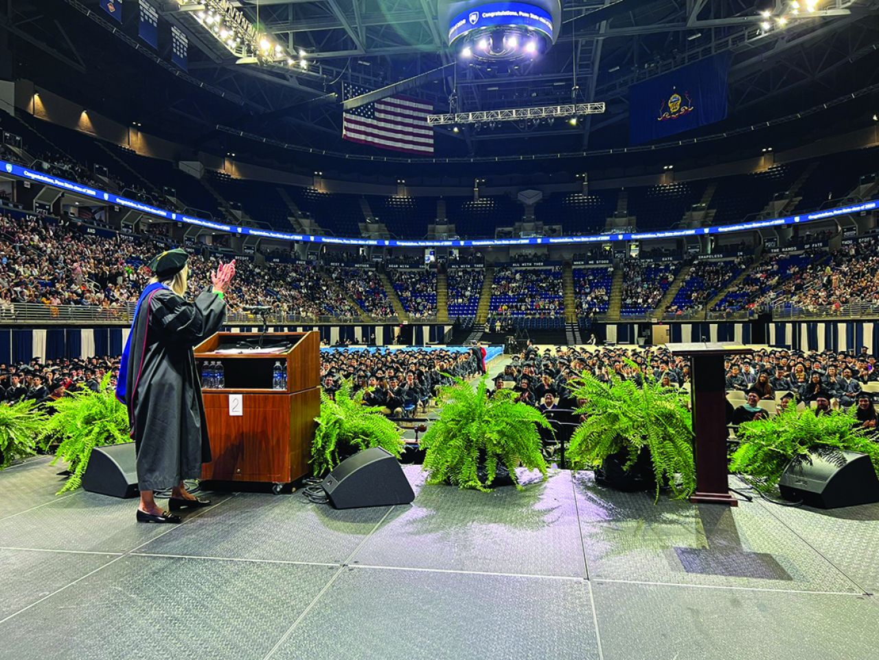 View of commencement from platform looking out at cap-and-gown clad students