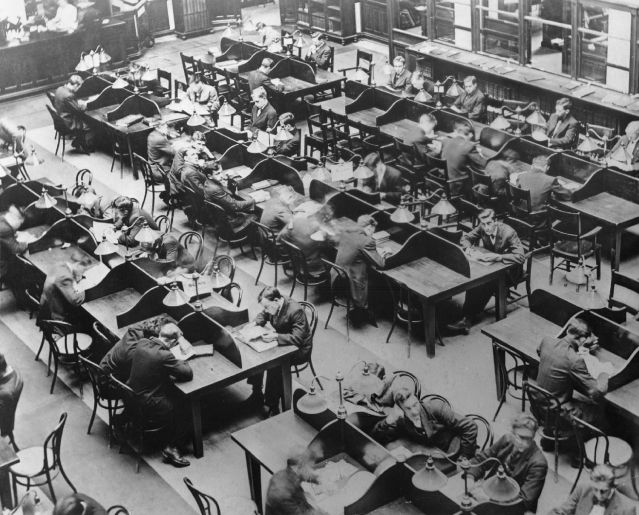 Overhead phto of students at desks reading and studying.