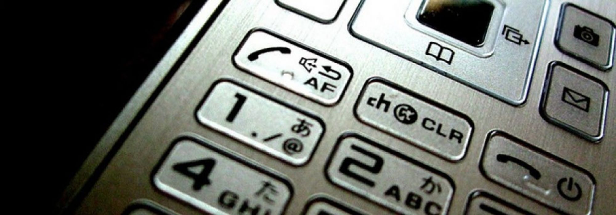 Close up photo of the number pad on an older mobile phone.